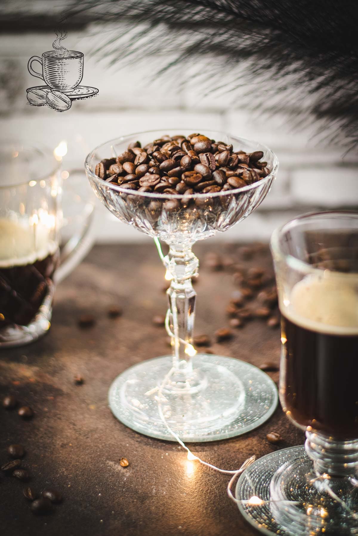 Gorgeous coffee glasses filled with hot coffee and cocktail glass filled with coffee beans standing on dark ground, surrounded by coffee beans.