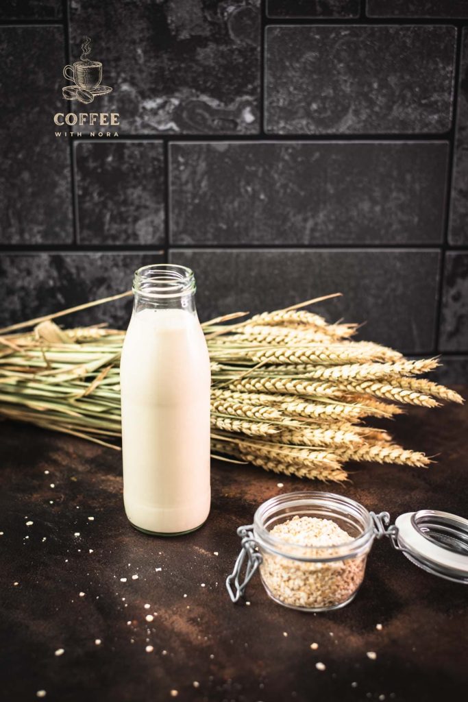 Milk bottle with oat milk on dark background.