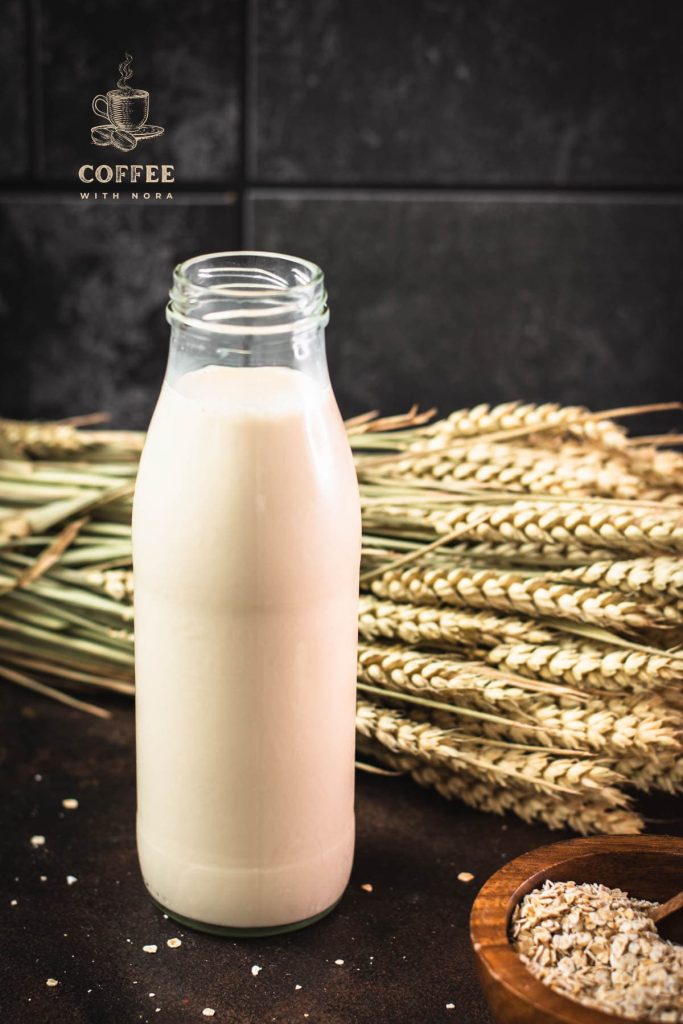 Milk bottle with oat milk on dark background.