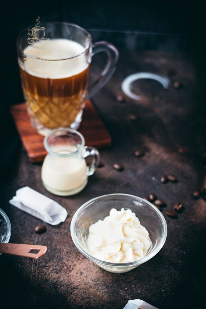 Whipped coffee creamer in small glass bowl.