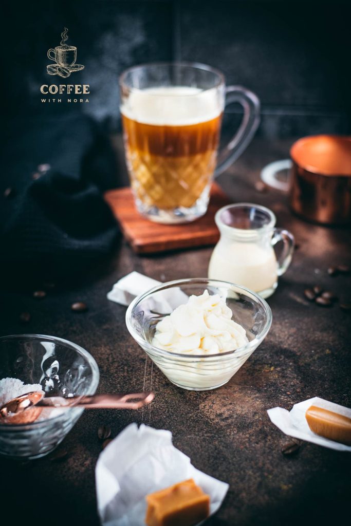 Whipped coffee creamer in small glass bowl.