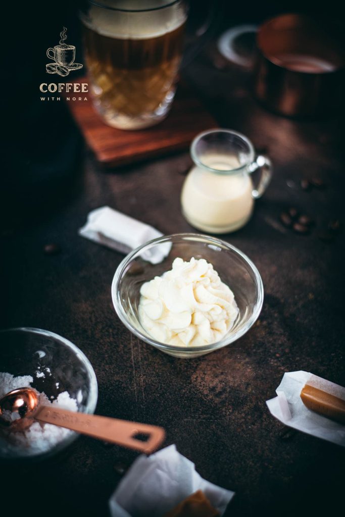 Whipped coffee creamer in small glass bowl.