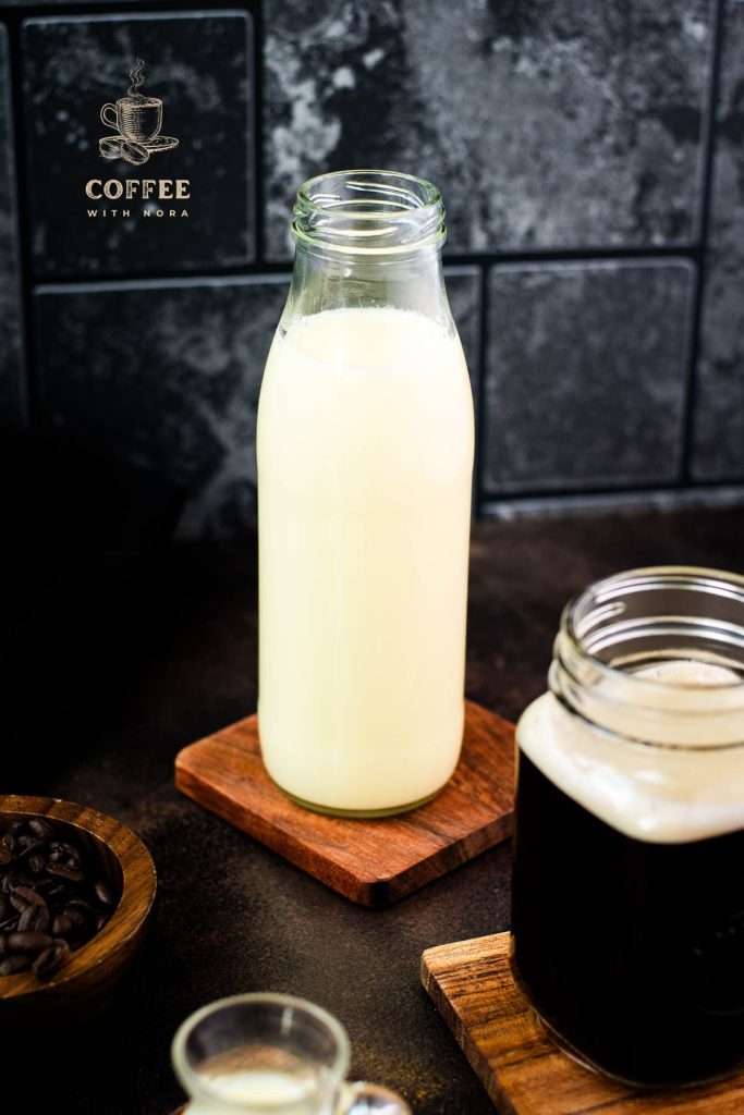 Big glass bottle filled with homemade coffee creamer.