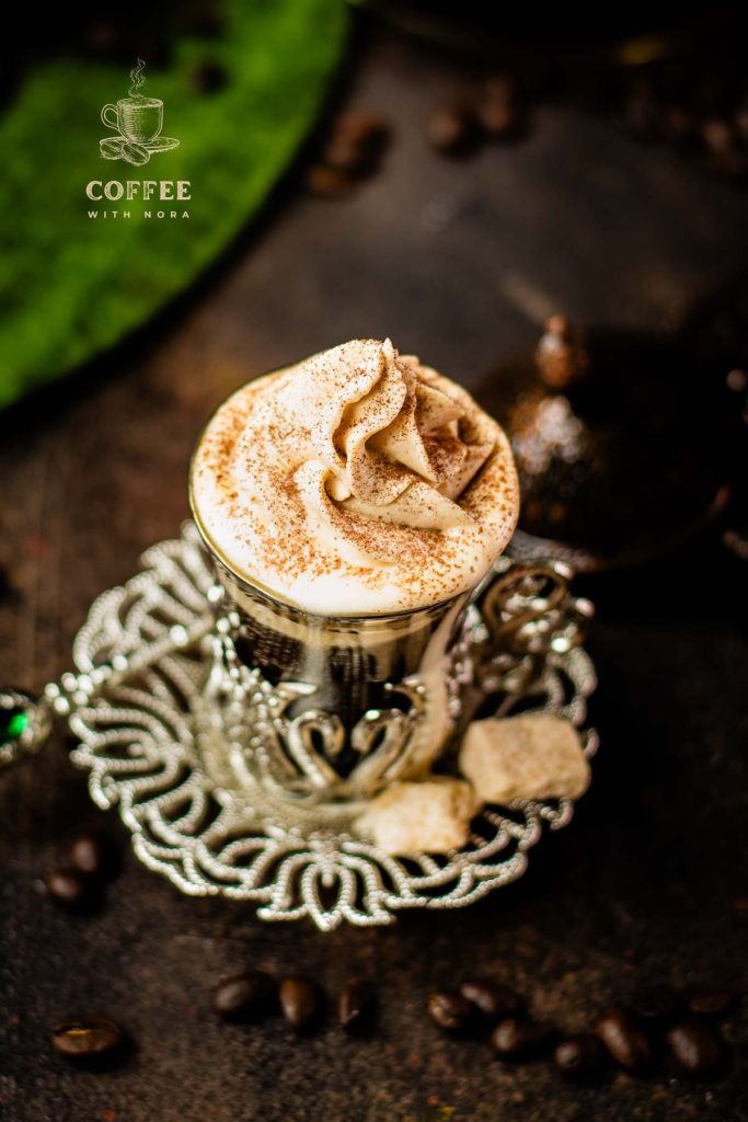 Beautiful pumpkin flavored whipped cream piped on black coffee.