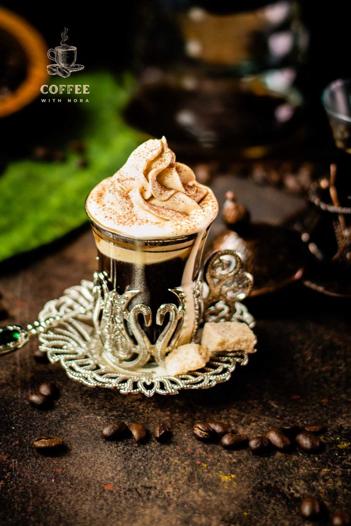 Beautiful pumpkin flavored whipped cream piped on black coffee.