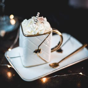 Gorgeous eggnog coffee, served in a handbag coffee mug. Topped with whipped cream and garnished with cocoa powder or nutmeg.