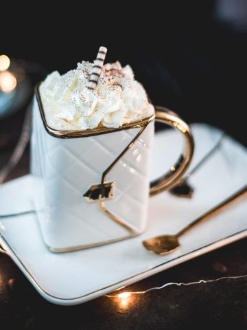 Gorgeous eggnog coffee, served in a handbag coffee mug. Topped with whipped cream and garnished with cocoa powder or nutmeg.