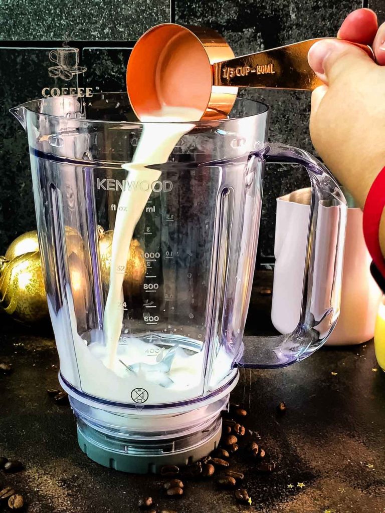 Add the milk into the blenders' jug.