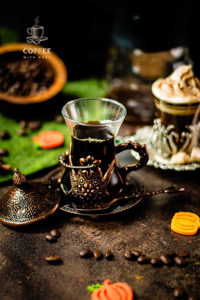 Delicious pumpkin spiced coffee with and without dairy topping filled in medieval serving glass.