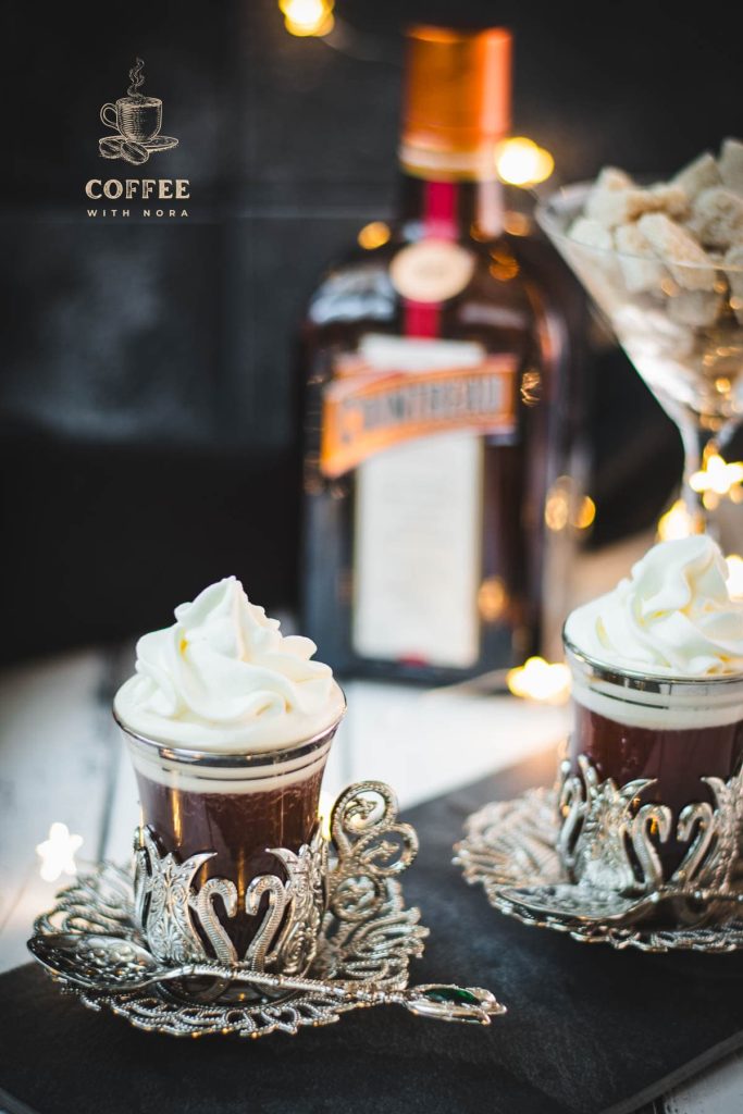 Gorgeous medieval coffee glass filled with delicious spiced Christmas coffee and topped with sweetened whipped cream.