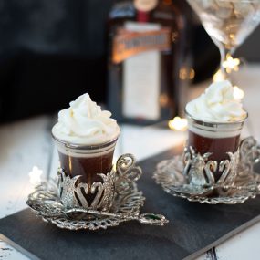 Gorgeous medieval coffee glass filled with delicious spiced Christmas coffee and topped with sweetened whipped cream.