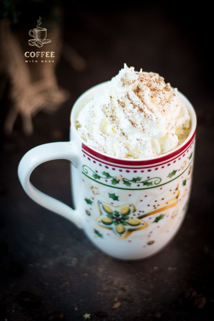 Gorgeous eggnog latte in cut Christmas coffee mug.