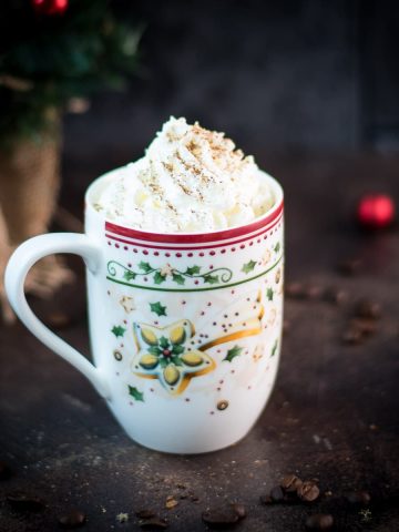 Gorgeous eggnog latte in cut Christmas coffee mug.