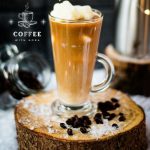 Gorgeous image of a high coffee glass, filled with iced coffee. The beautiful snowflake shaped milk ice cubes make this treat even more appealing.