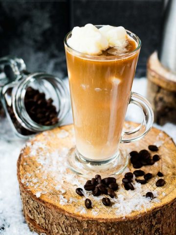 Gorgeous image of a high coffee glass, filled with iced coffee. The beautiful snowflake shaped milk ice cubes make this treat even more appealing.