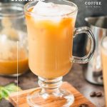 Tall, narrow coffee glass filled with iced caramel latte, with homemade caramel milk. Placed on wooden coaster.