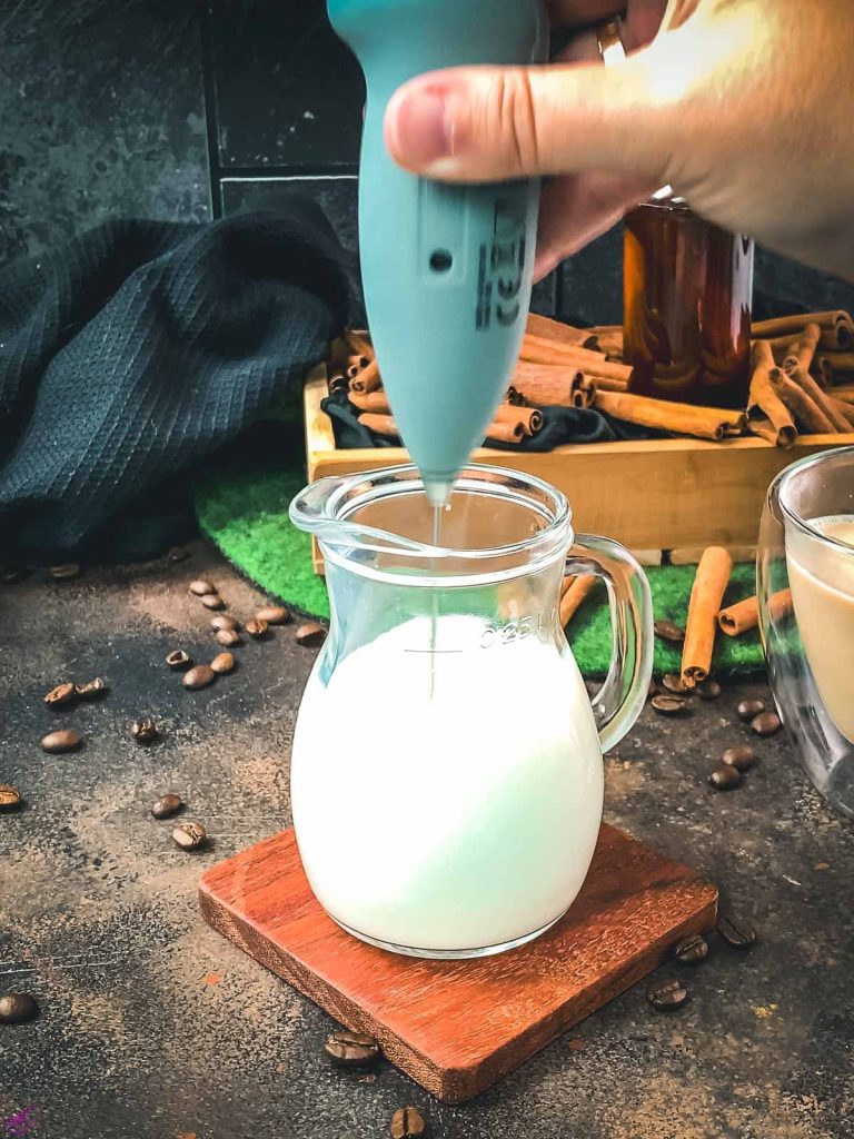 Froth the milk with a handheld milk frother.