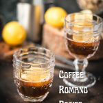 Two beautiful glasses filled with coffee and a slice of lemon stand on a dark background.