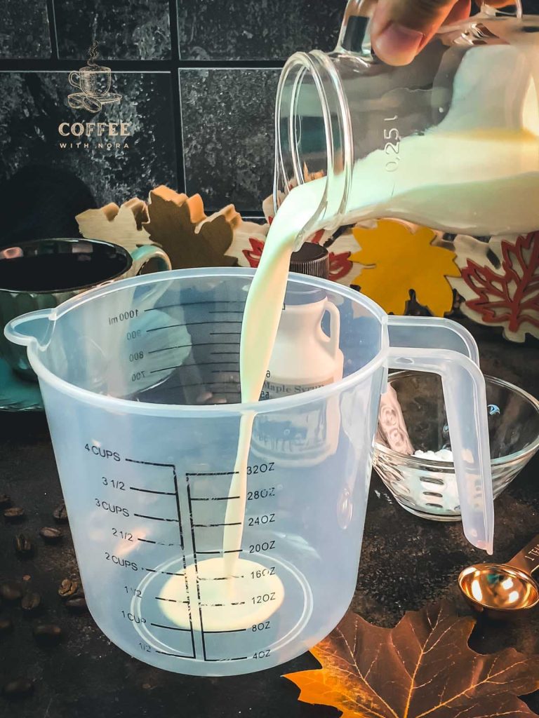 Pour the cream into a tall measuring cup.