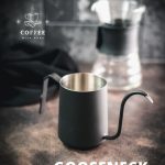 Gorgeous black gooseneck kettle on dark ground placed next to a V60 Pour Over Kit.