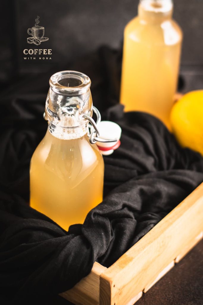 Preserving bottle filled with delicious lemon ginger syrup.