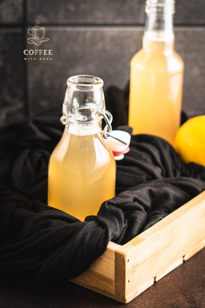 Preserving bottle filled with delicious lemon ginger syrup.