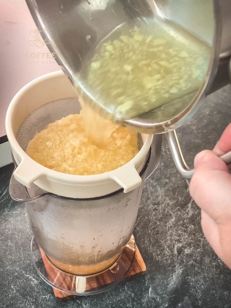 Strain the ginger and lemon mixture through a sieve into a measuring jug.