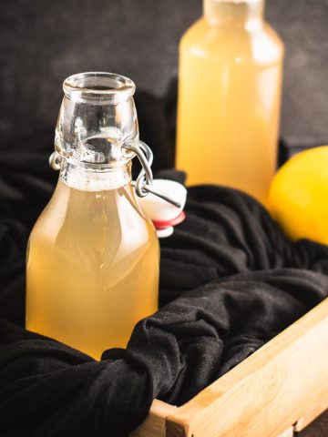 Preserving bottle filled with delicious lemon ginger syrup.