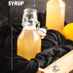 Preserving bottle filled with delicious lemon ginger syrup.