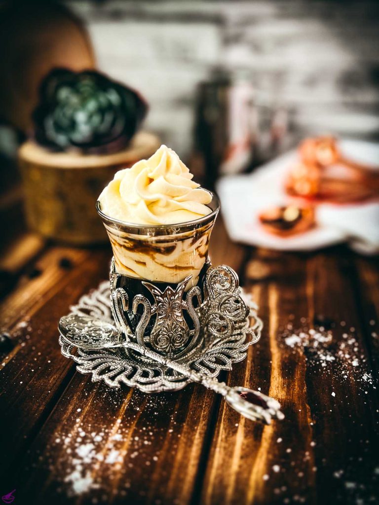 Gorgeous espresso whipped cream, topping an espresso and served in an medieval glass cup. The delicious texture also makes the espresso whipped cream a feast for the eyes!