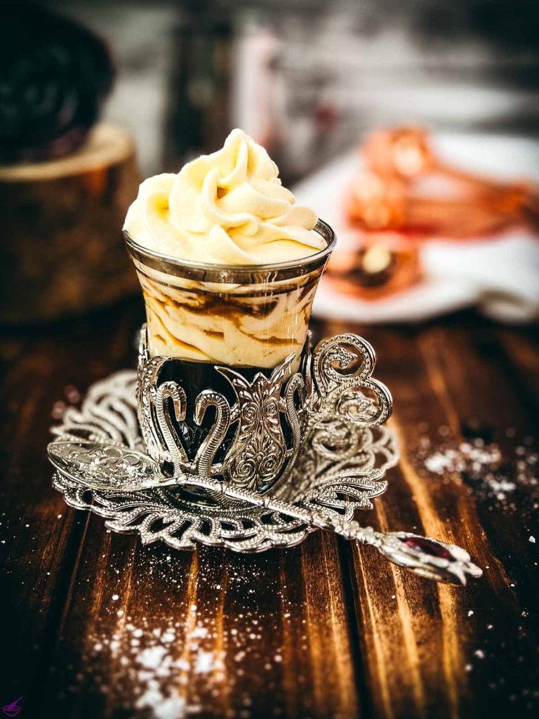 Gorgeous espresso whipped cream, topping an espresso and served in an medieval glass cup. The delicious texture also makes the espresso whipped cream a feast for the eyes!