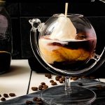 Gorgeous marbled cold brew white Russian made with half-and-half, placed on marbled plate.