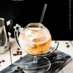 Gorgeous marbled cold brew white Russian made with half-and-half, placed on marbled plate.