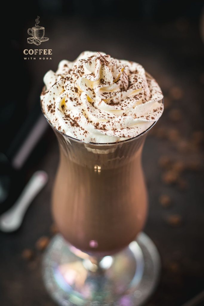 Delicious iced chocolate coffee with sweet whipping cream on top. Dusted with cocoa powder and served in a hurricane glass.