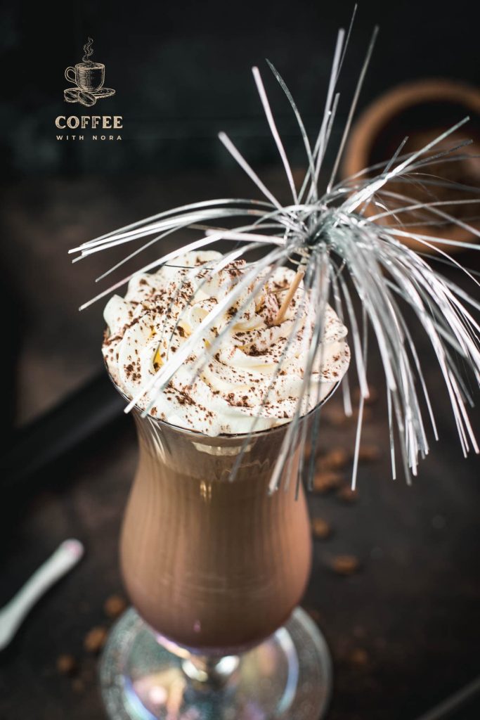 Delicious iced chocolate coffee with sweet whipping cream on top. Dusted with cocoa powder and served in a hurricane glass.