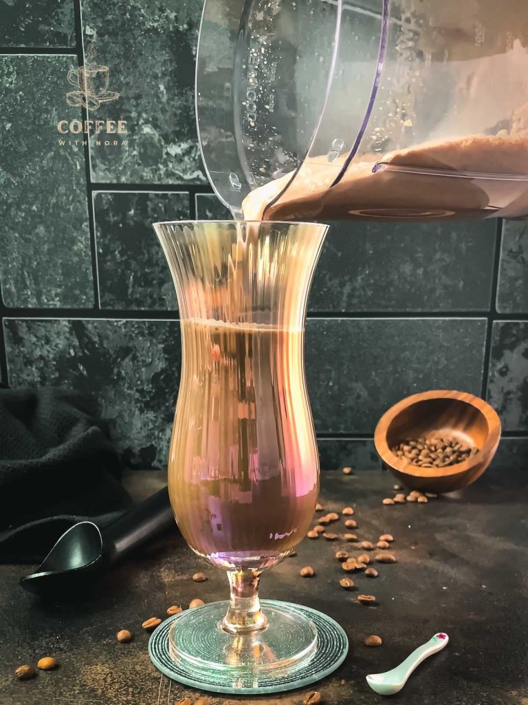 Pour the chocolate iced coffee into the hurricane glass.