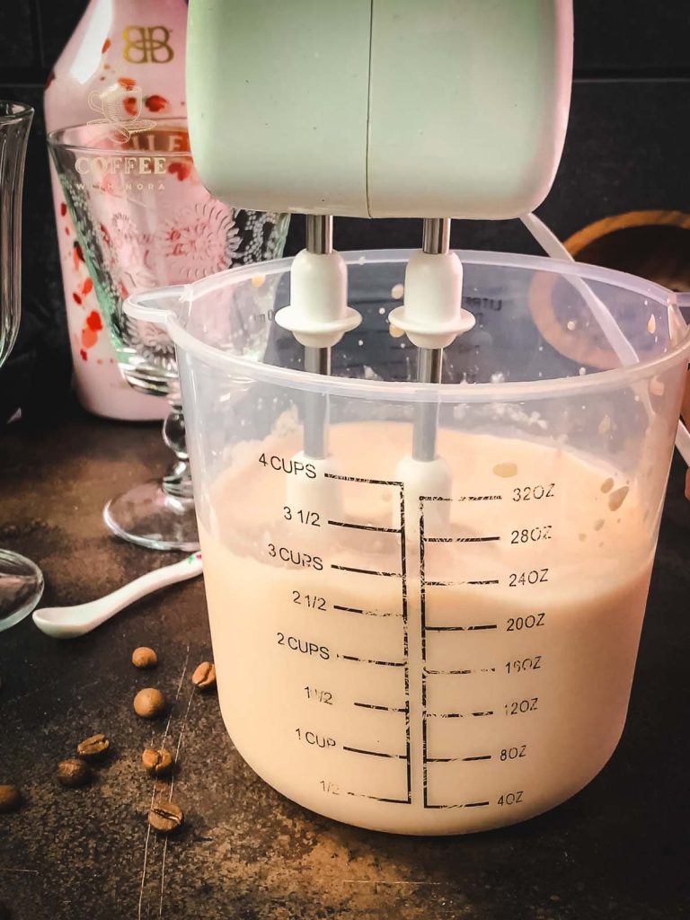 Mix the strawberry iced coffee using an electric hand mixer.