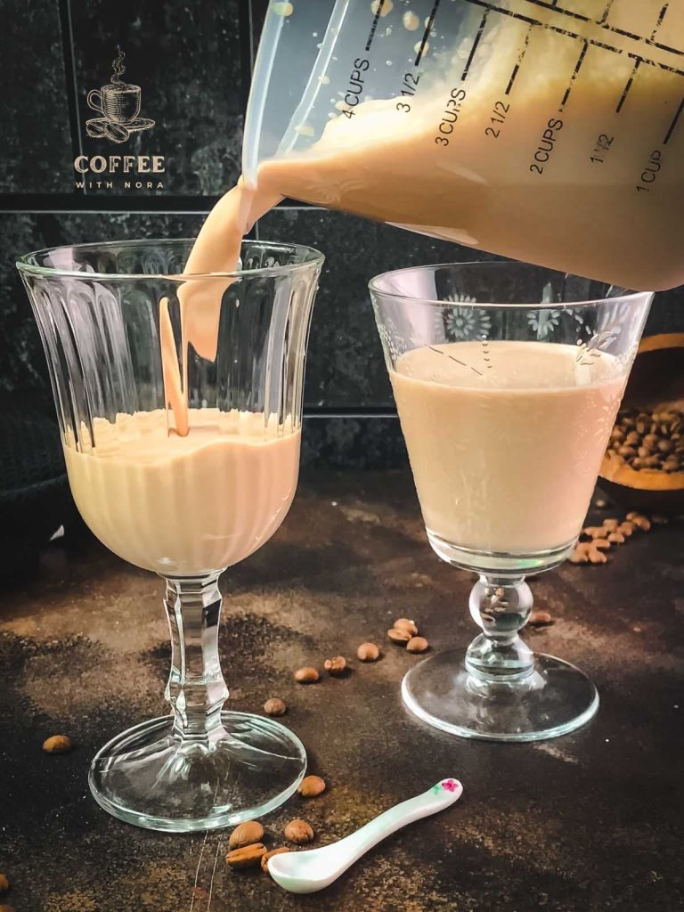 Pour the strawberry iced coffee into the serving glasses.