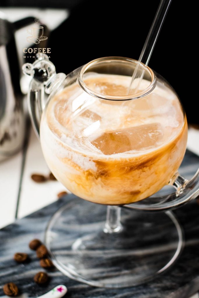 Gorgeous marbled cold brew white Russian made with half-and-half, placed on marbled plate.