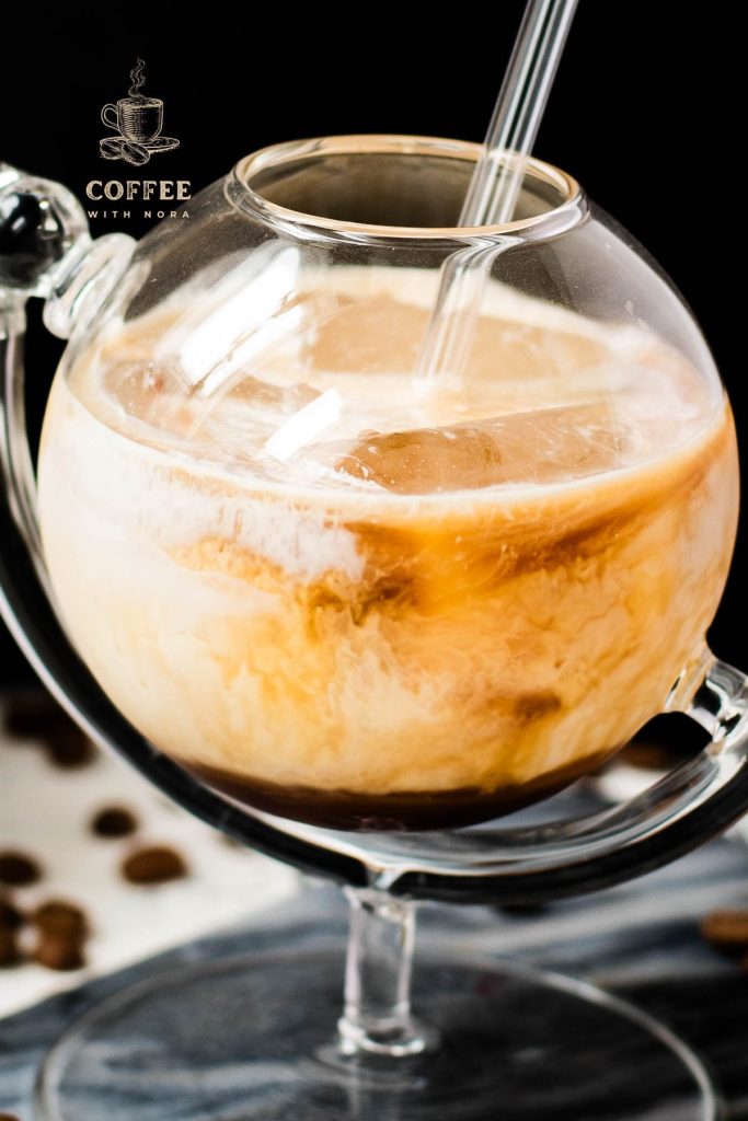 Gorgeous marbled cold brew white Russian made with half-and-half, placed on marbled plate.