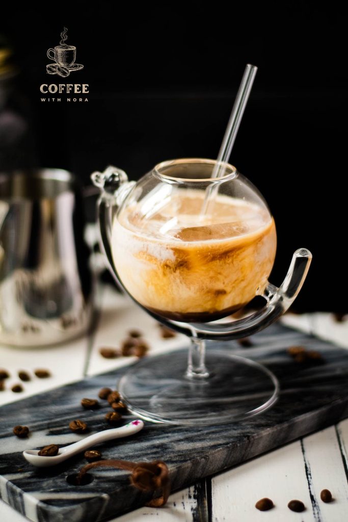 Gorgeous marbled cold brew white Russian made with half-and-half, placed on marbled plate.