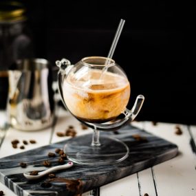 Gorgeous marbled cold brew white Russian made with half-and-half, placed on marbled plate.