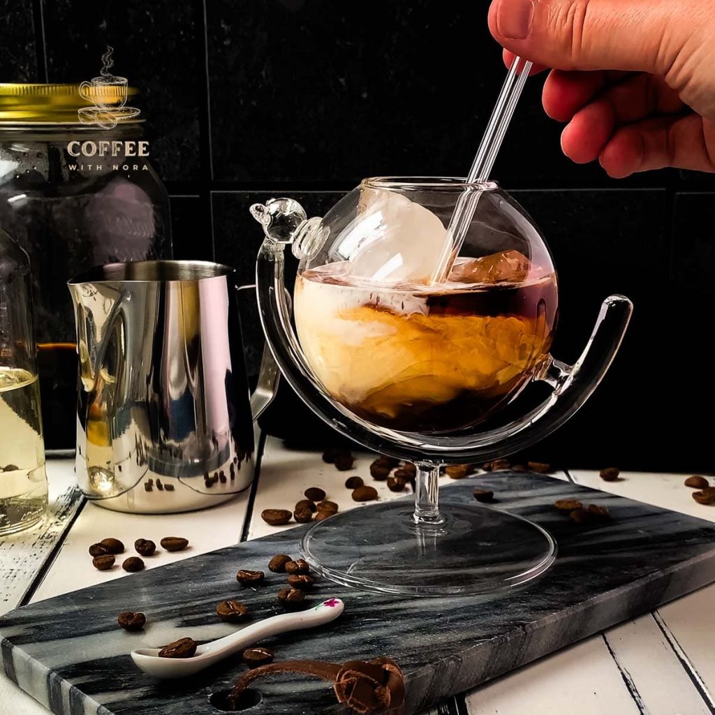 Adding a drinking straw to the cold brew white russian.