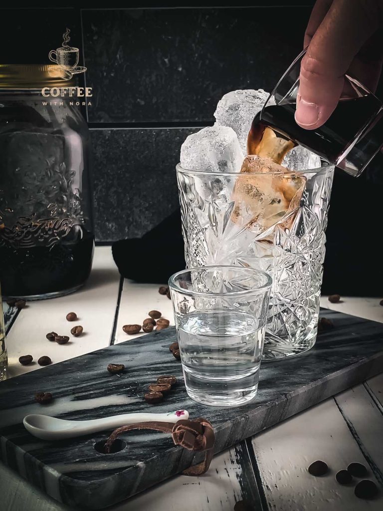 Pouring the cold brew into the rocks glass.