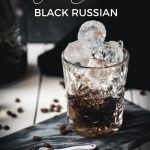 Gorgeous cold brew black Russian served in a rocks glass and placed on a marbled plate.