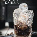 Gorgeous cold brew black Russian served in a rocks glass and placed on a marbled plate.