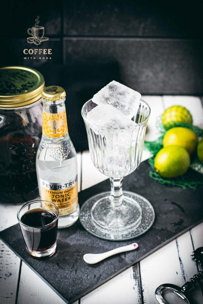 Cold brew tonic ingredients - cold brew, tonic and a lime slice for garnish.