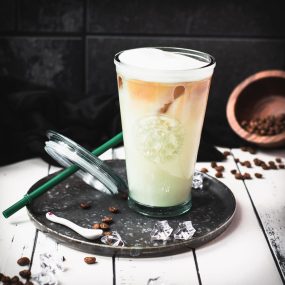 Yummy classic iced latte placed on metal tray.