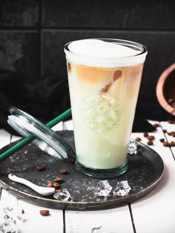 Yummy classic iced latte placed on metal tray.