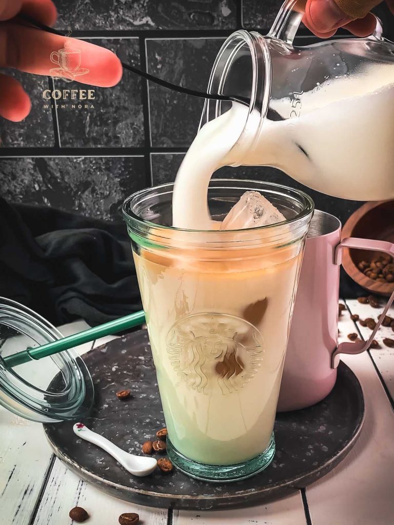 Top the iced latte with frothed milk.